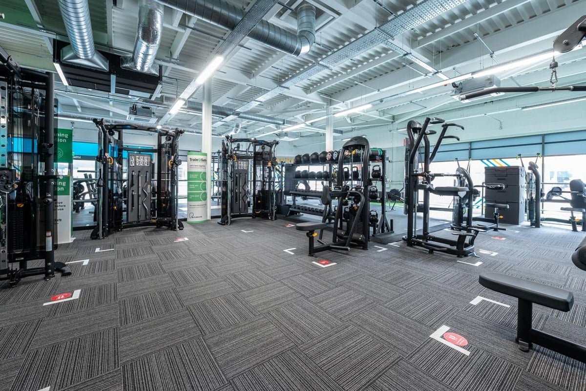 PureGym Aldershot Westgate Retail Park: Resistance machines, squat racks, and weight benches in a spacious training area.
