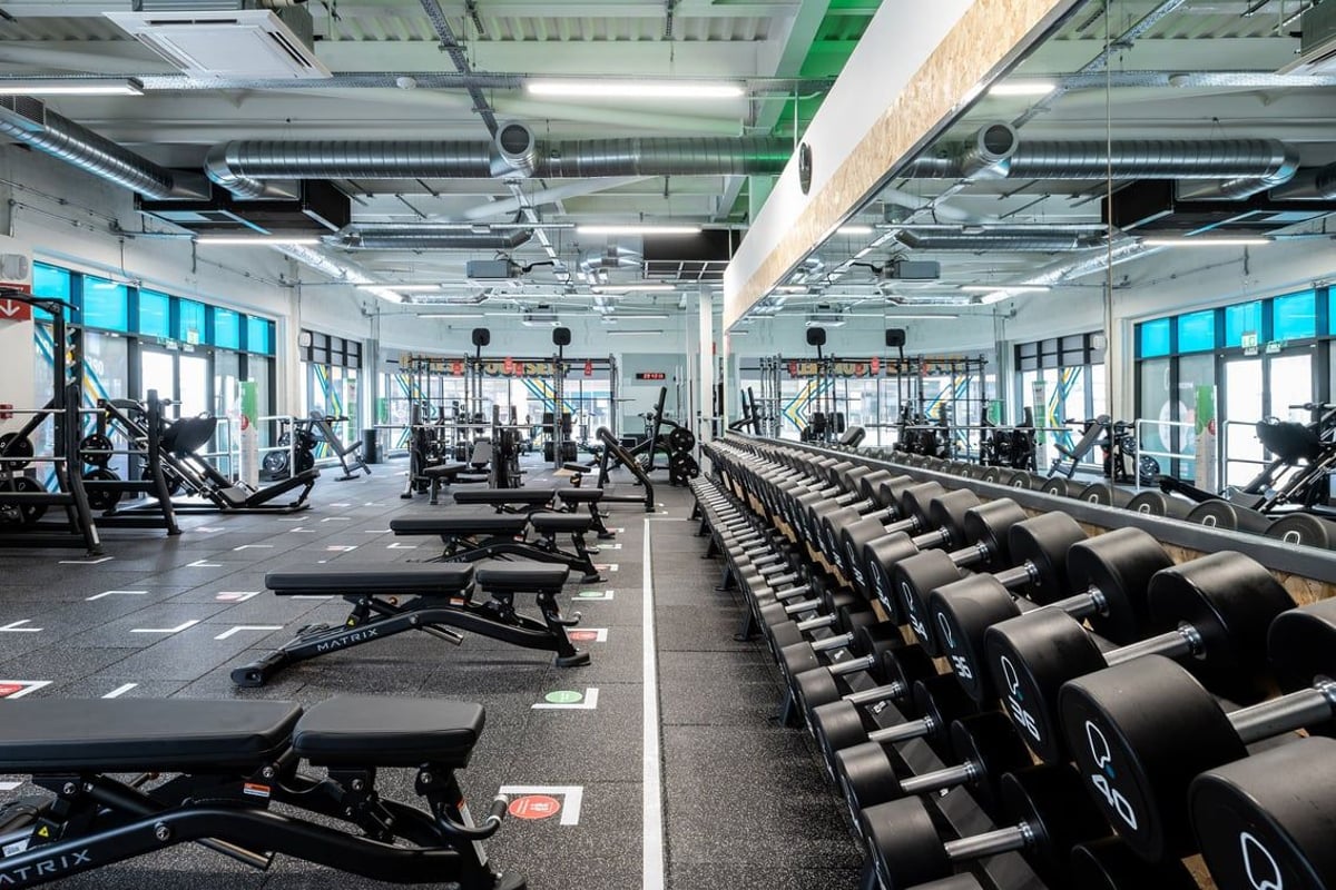 PureGym Aldershot Westgate Retail Park: Rows of weight benches, free weights, and resistance machines in a bright gym space.