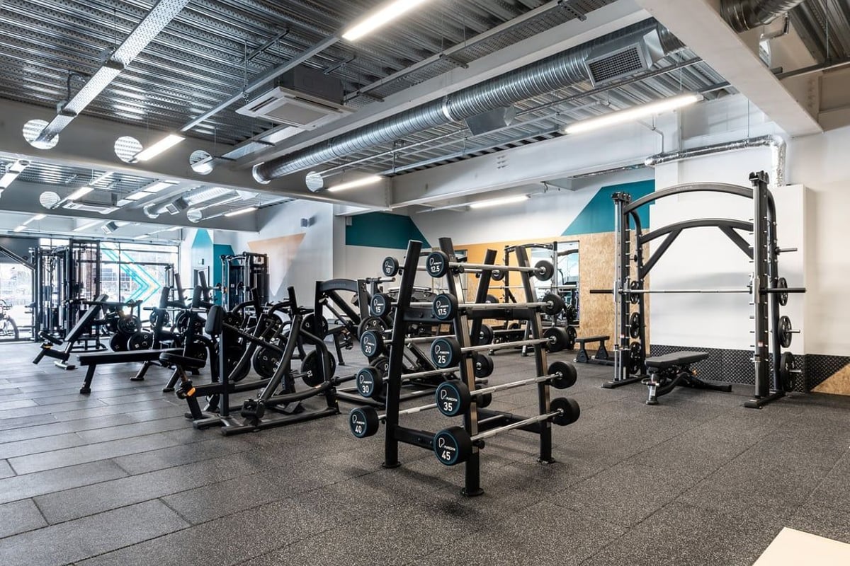 PureGym Yate: Resistance machines, free weights, squat racks, benches, and rubberized flooring in a gym setting.