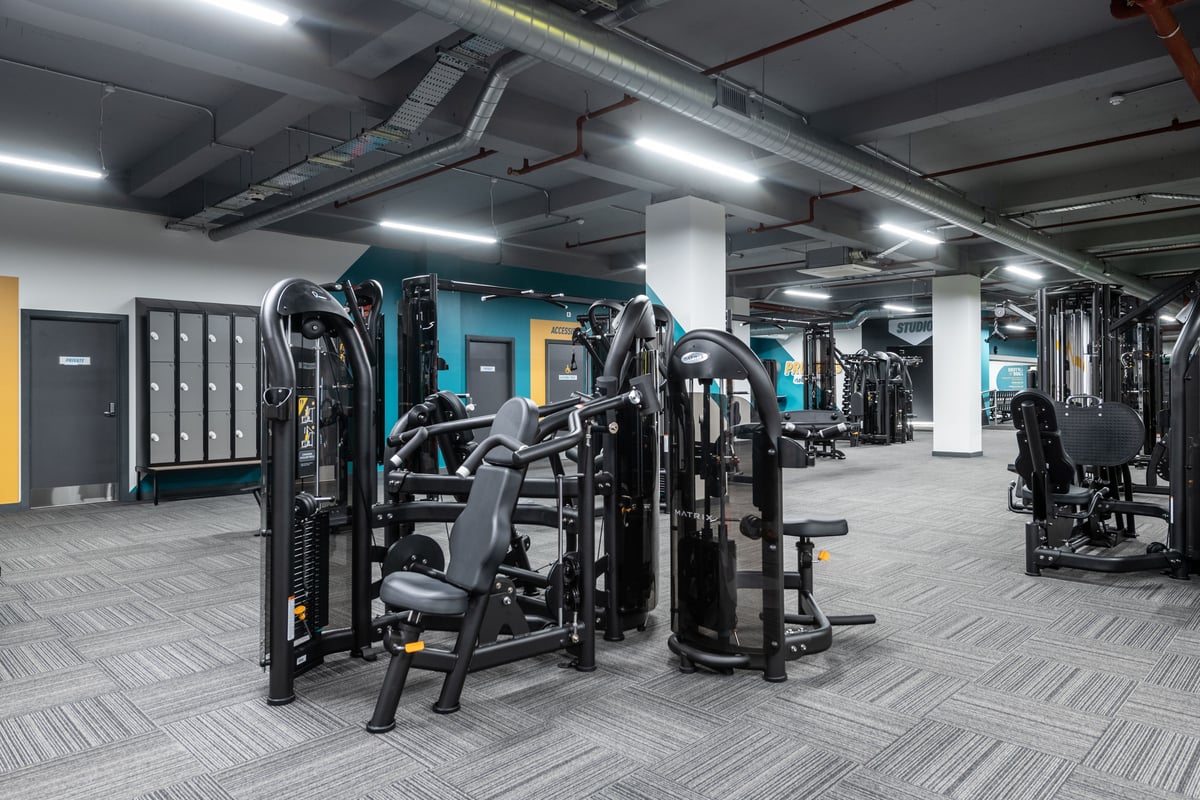 PureGym London Kingston: Resistance machines, free weights, benches, and rubberized flooring in a well-equipped gym interior.