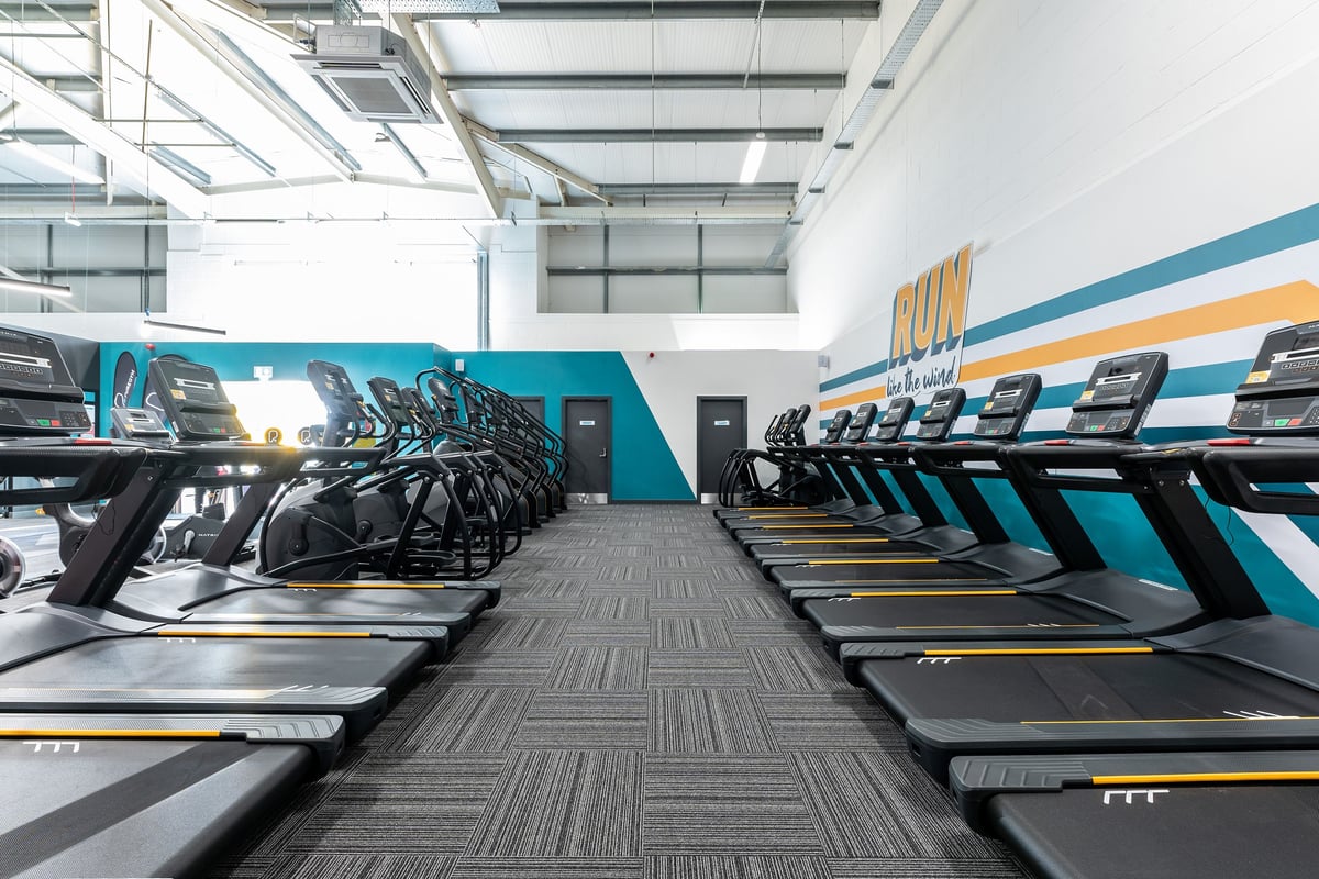 PureGym Great Yarmouth: Rows of treadmills and other cardiovascular exercise machines in a bright gym interior.