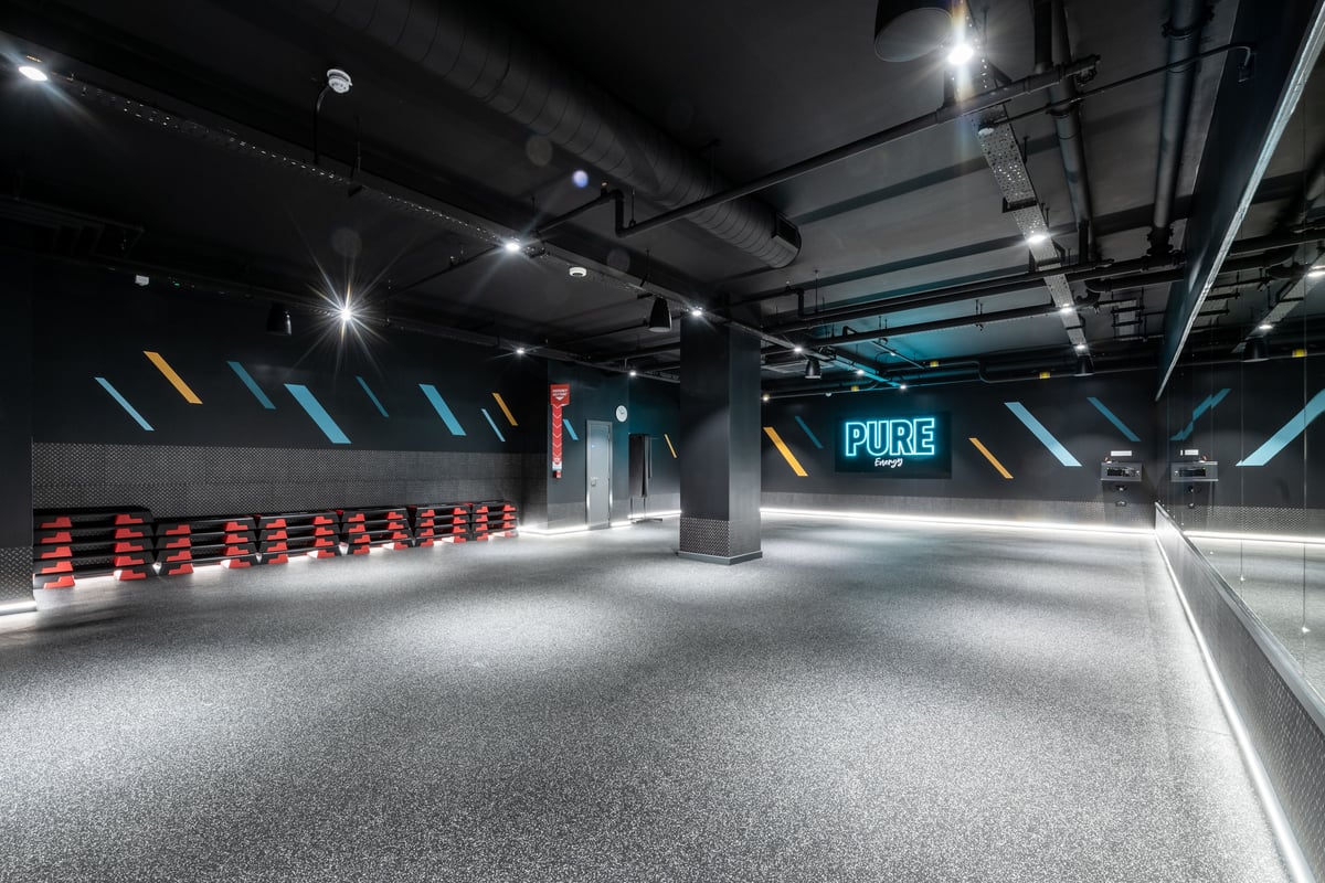 PureGym London Kingston: Fitness stdudio with stacks of step platforms opposite a mirrored wall.