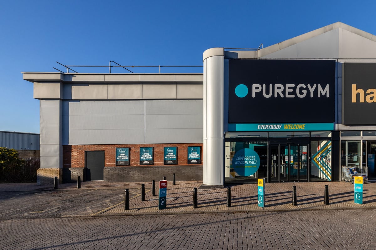 PureGym Hull Clough Road: Exterior of a modern gym facility with branded signage and paved entrance area.