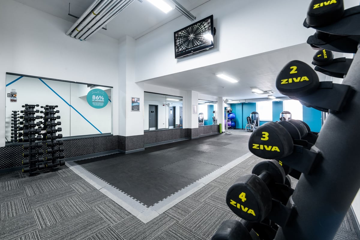 PureGym Gateshead stretch area with mirror and dumbbells