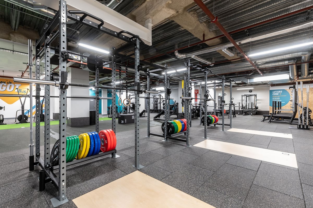 PureGym London Monument: Strength area with squat racks, weight plates, rubberized flooring, and functional training rigs.