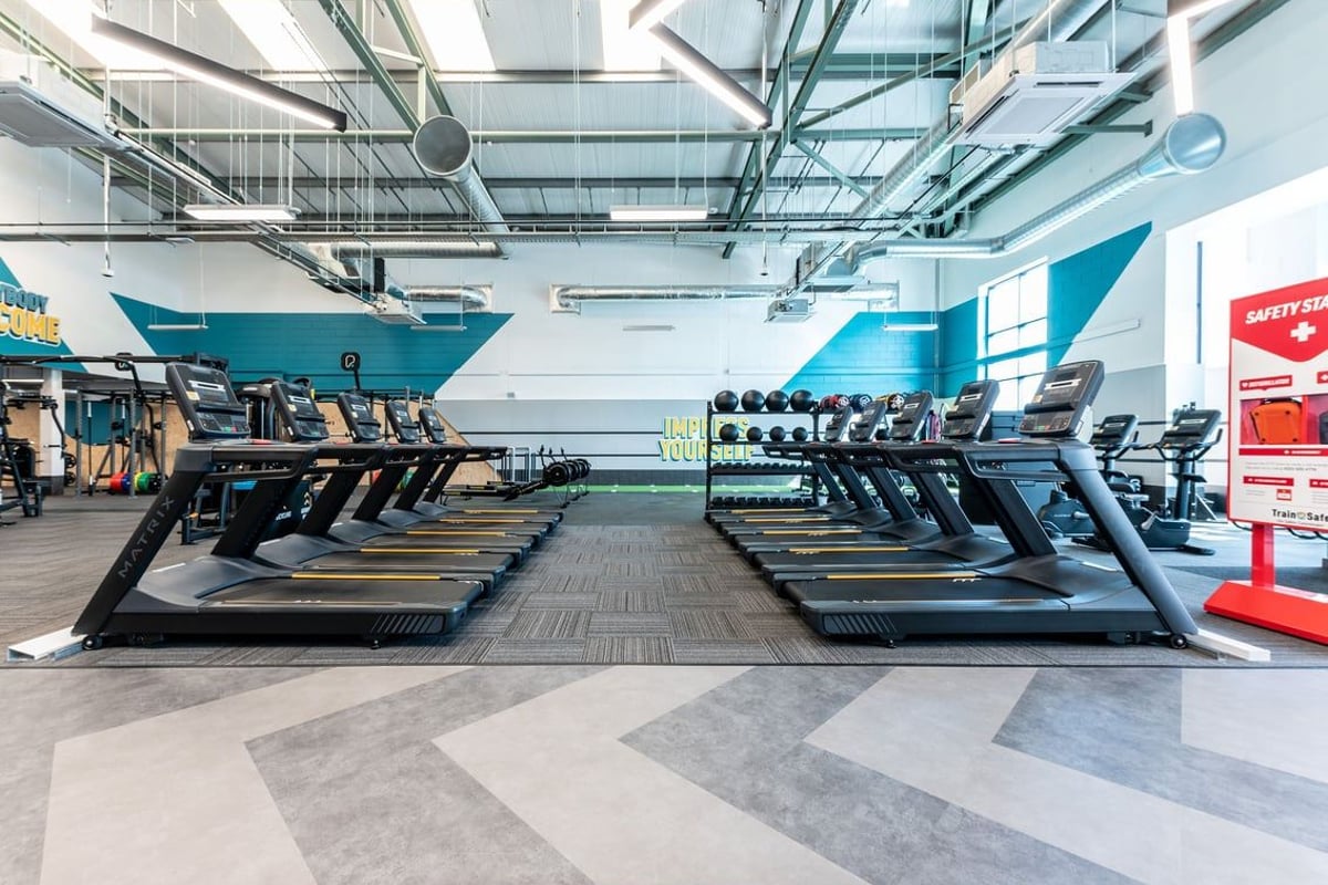 PureGym Coleraine: Rows of treadmills, static bikes, and elliptical machines in a brightly lit gym facility.