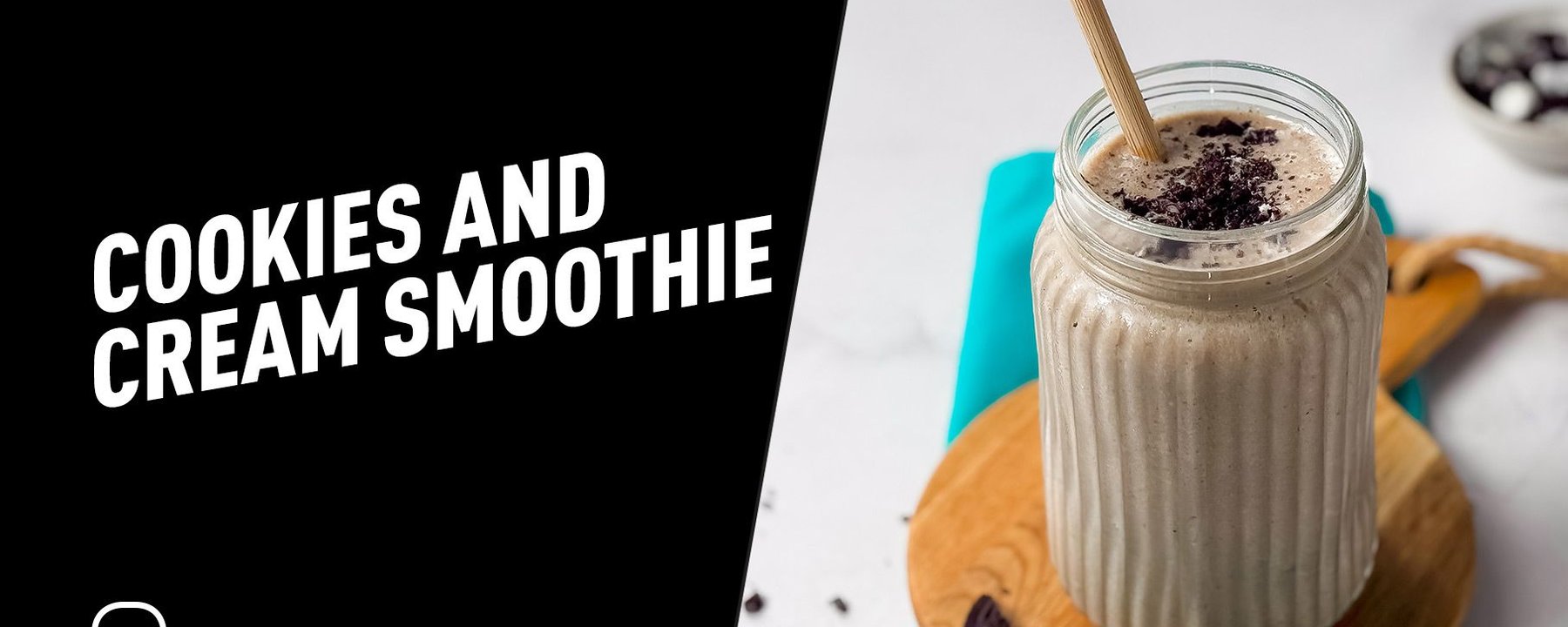 Cookies and cream smoothie in a glass jar with a wooden straw on a wooden board