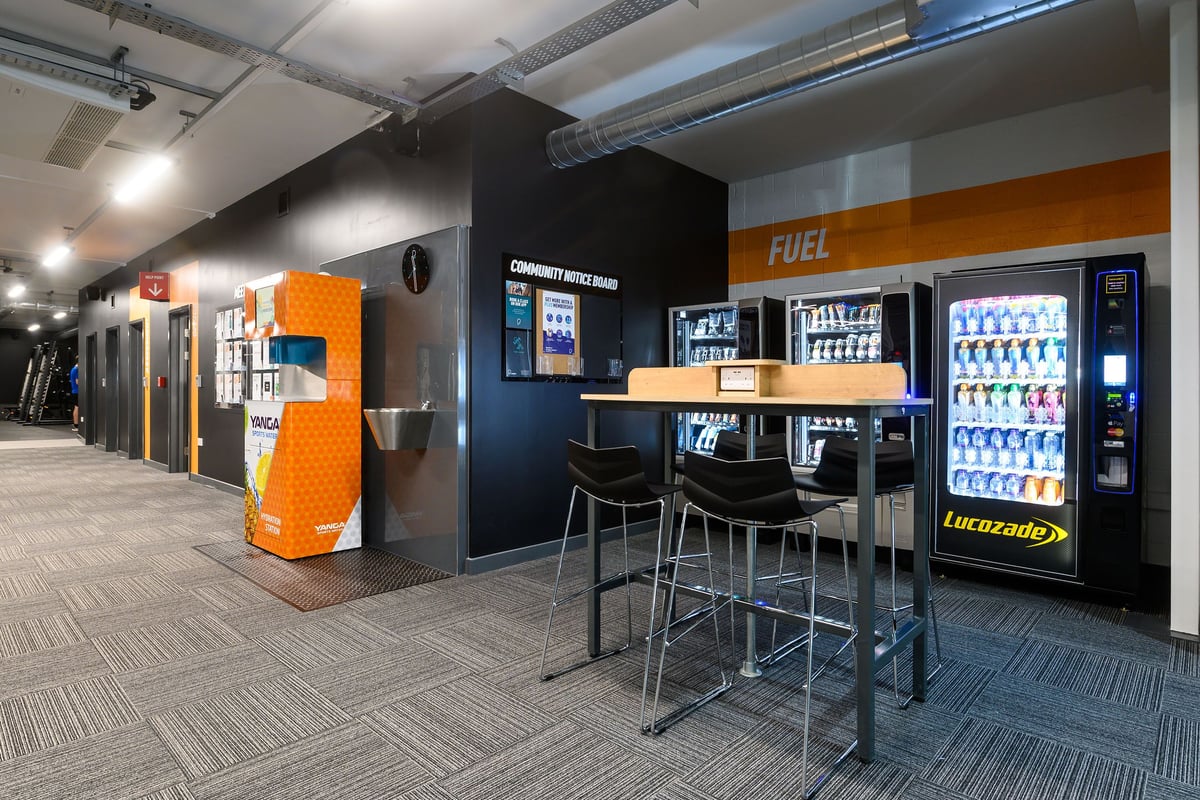 PureGym Bristol Abbey Wood Retail Park: Vending machines, seating area, fridges stocked with sports drinks and snacks.