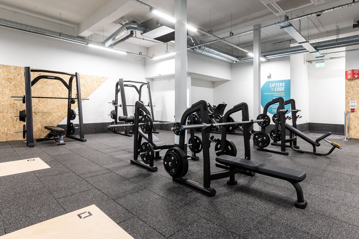 PureGym Edinburgh Craigleith Retail Park: Gym studio with weight racks, benches, black equipment, and rubberized flooring.