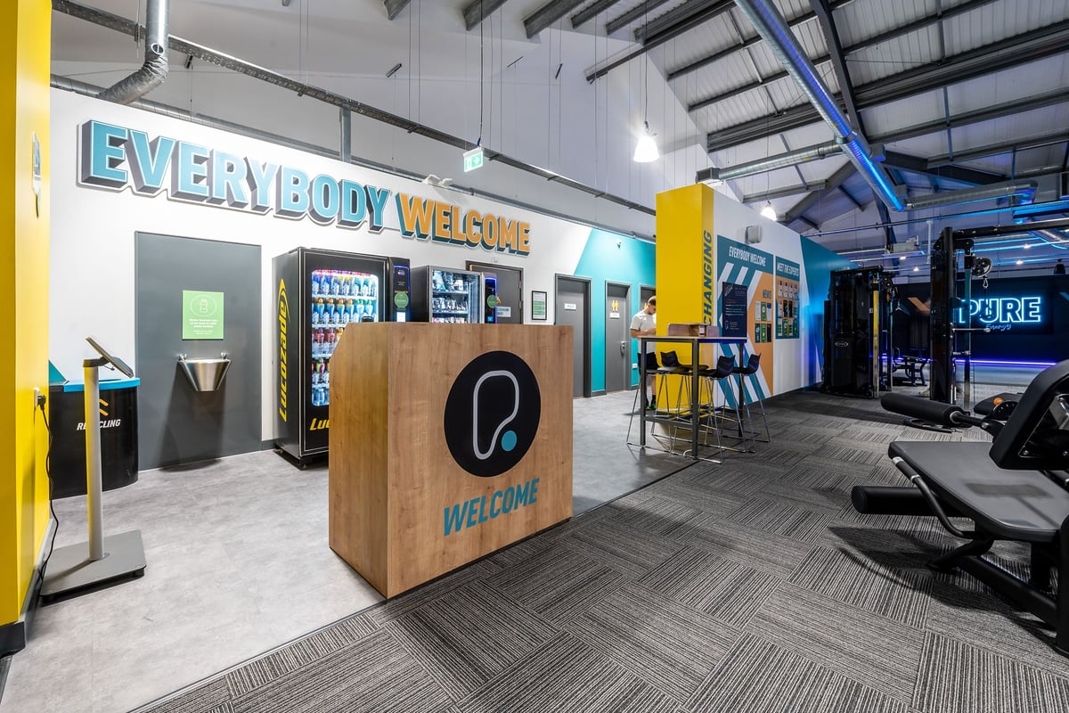 PureGym Stowmarket: Reception area, vending machines, seating, and strength equipment visible.