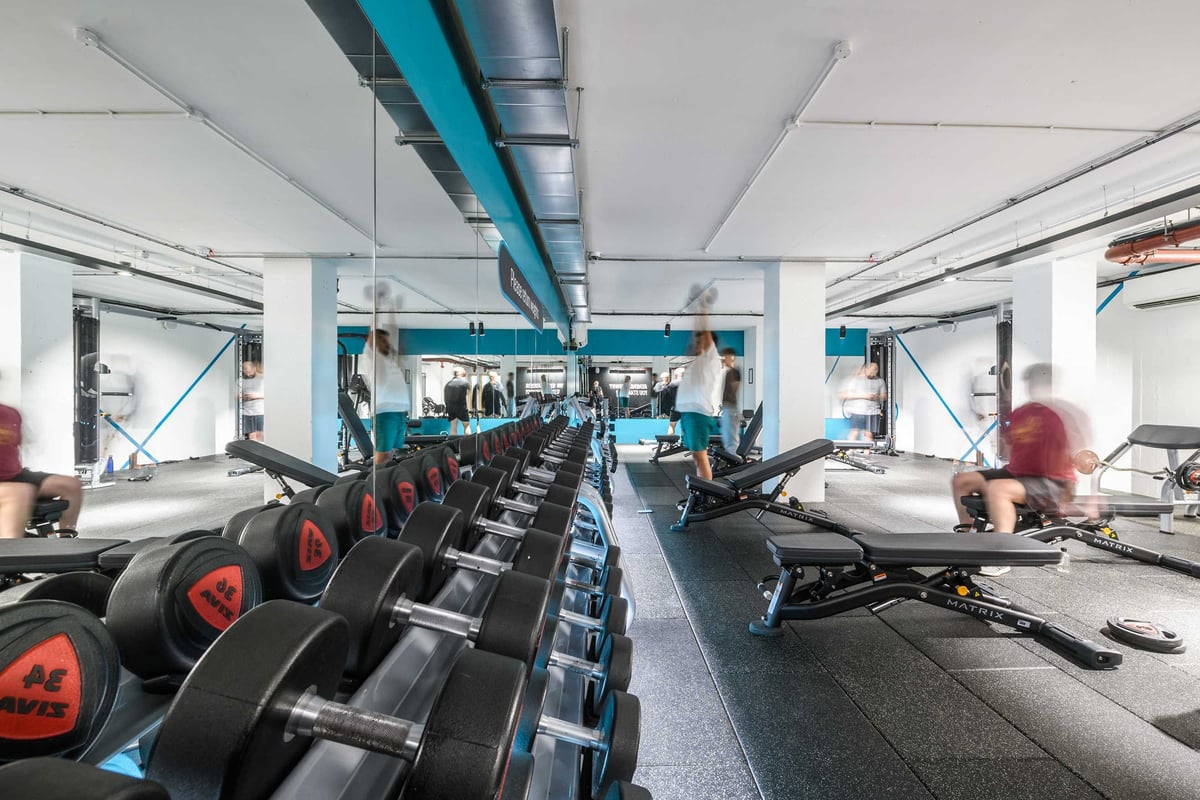 PureGym London Farringdon: free weights, benches on rubberised flooring in spacious gym.