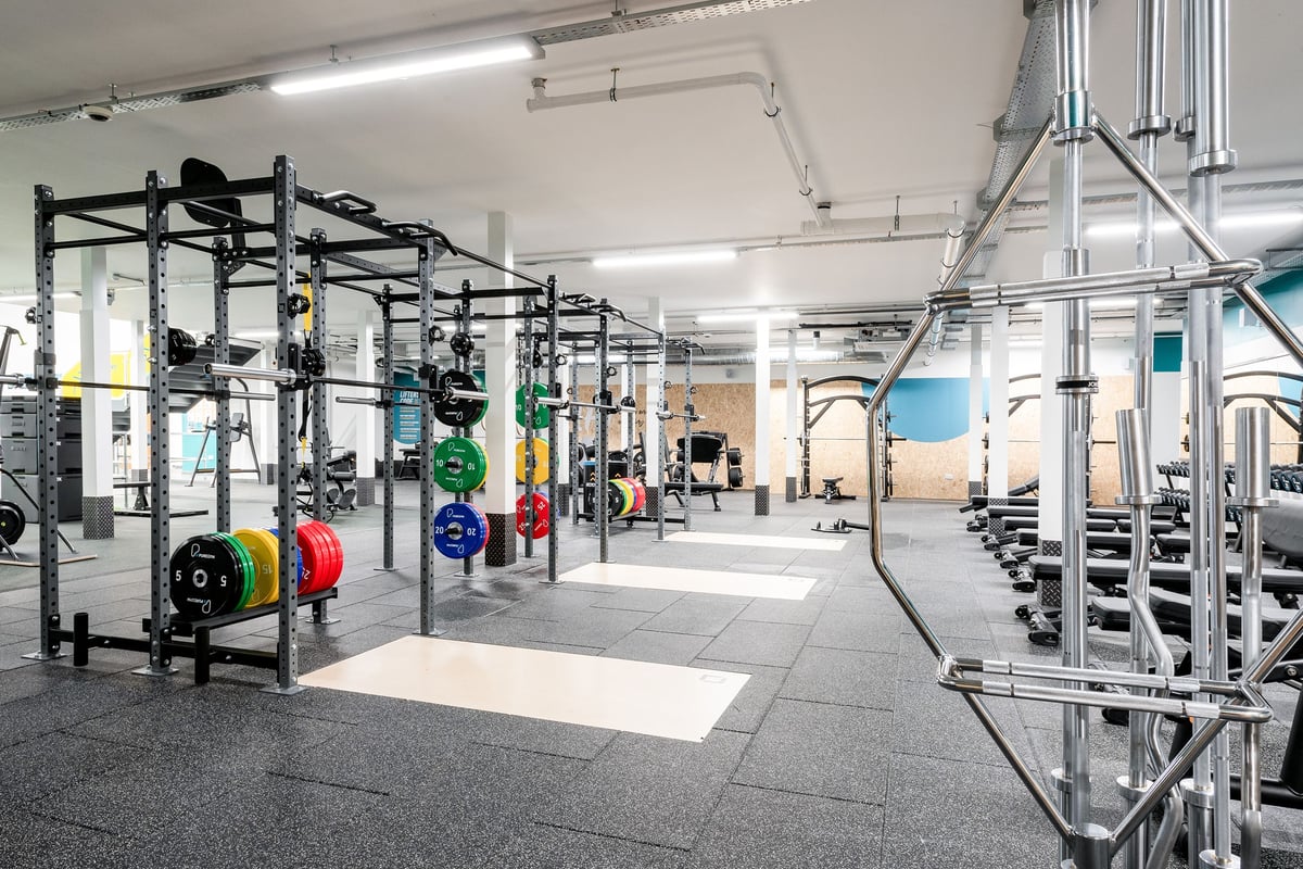 PureGym Cannock Orbital Retail Park: Squat racks, weightlifting platforms, barbells, weight plates, and rubberized flooring.