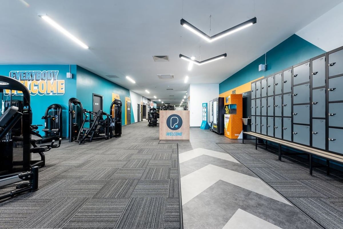 PureGym Selby: Resistance machines, lockers, chevron floor tiles in an interior gym setting.