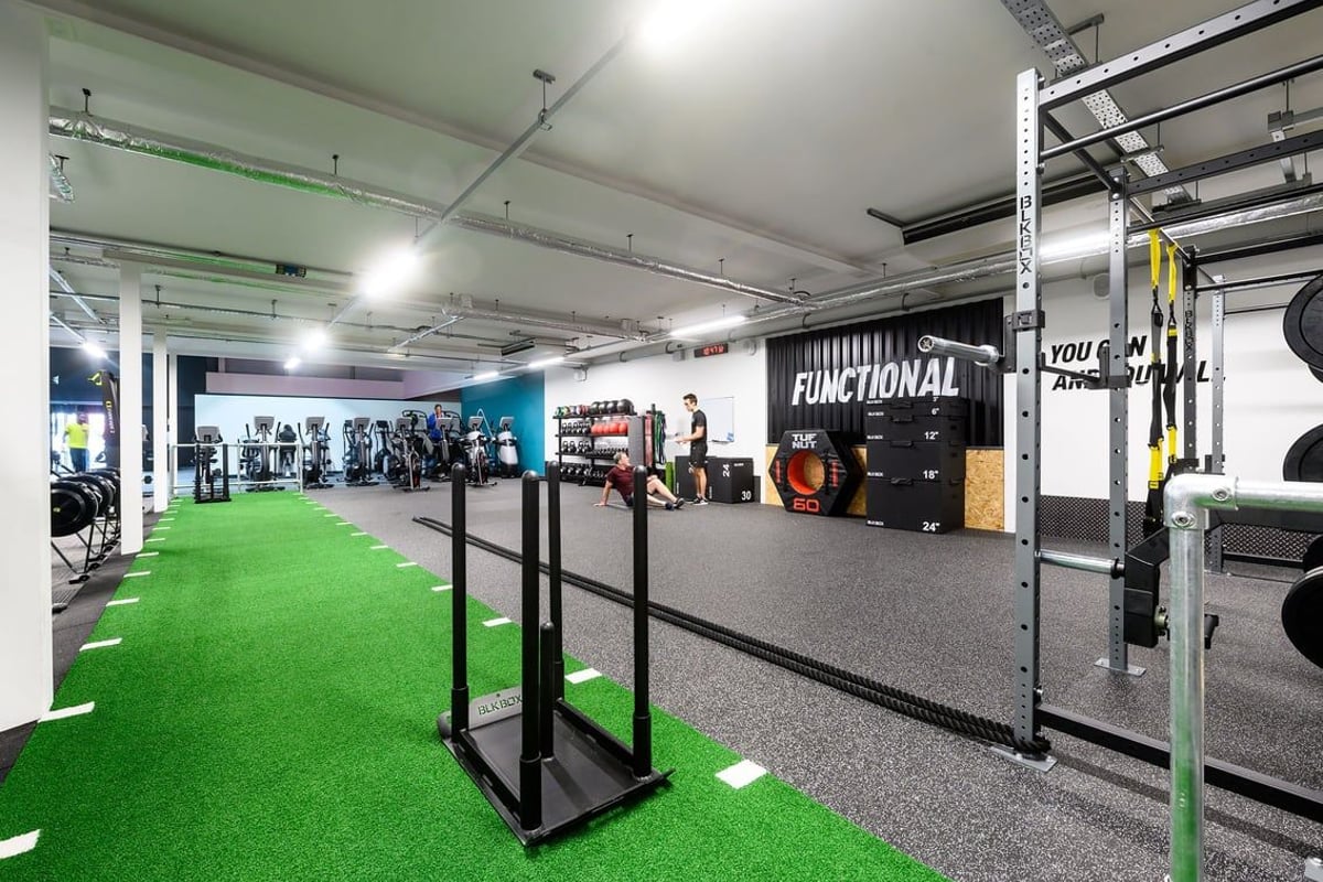 PureGym Bristol Abbey Wood Retail Park: Gym studio with functional training rig, green turf area, weights racks, mirrors.