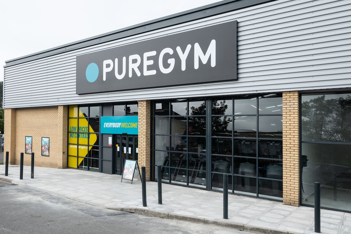 PureGym Dover: Pure Gym exterior signage with entrance and windows showing exercise studio interior.