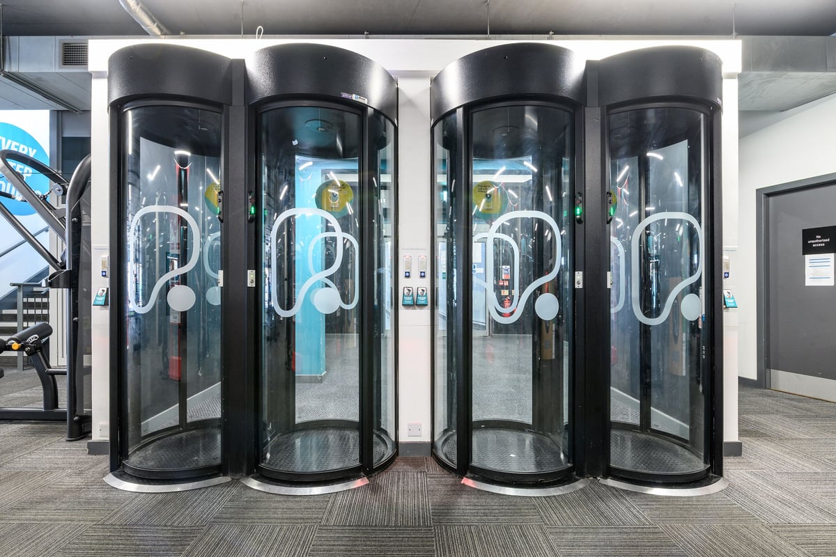 PureGym London Greenwich: Entrance pods with transparent glass panels.