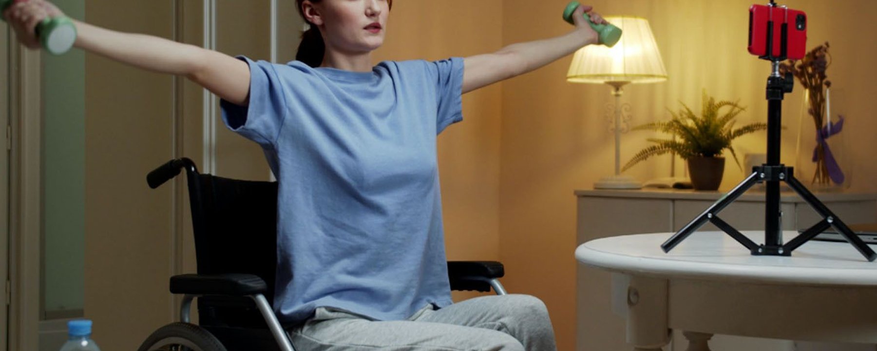 lady in a wheelchair with dumbbells