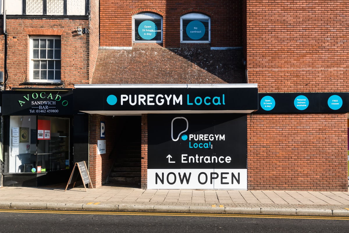 PureGym Hitchin: Gym front entrance signage and logos indicating "PUREGYM Local" now open.