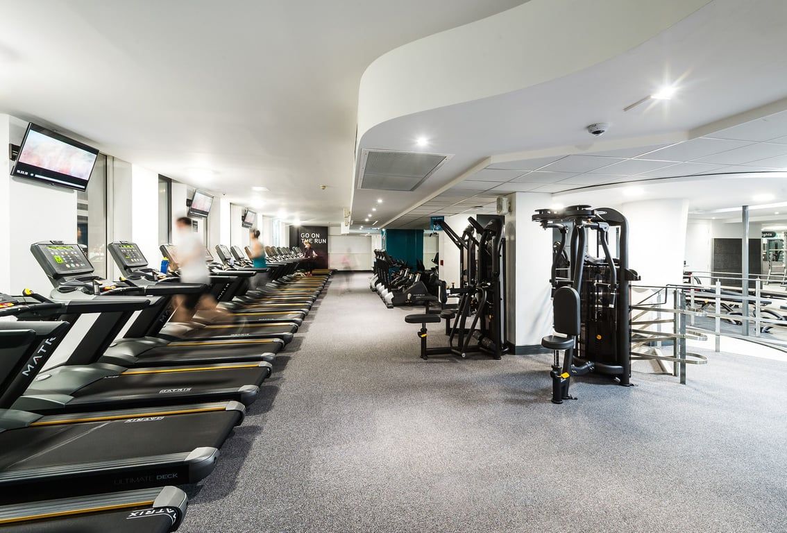 PureGym London Holborn: Rows of treadmills, weight machines, and strength equipment in a modern, well-lit fitness center.