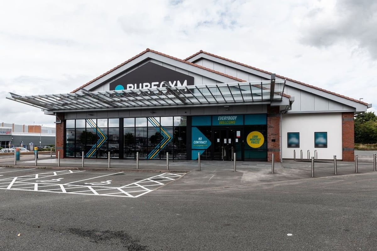 PureGym Derby Meteor Centre: Exterior of a fitness center building with 'PureGym' signage and parking spaces.