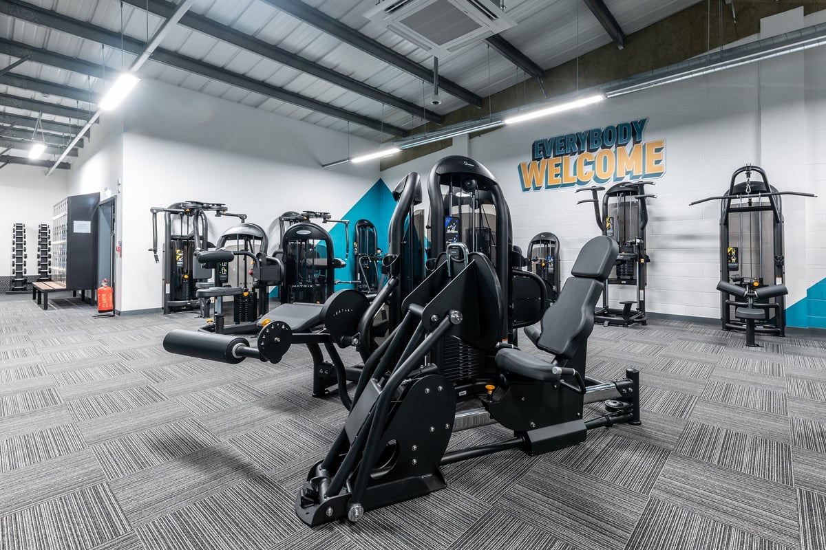 PureGym Shrewsbury Meole Brace: Rows of resistance machines, weight stacks, and rubberized flooring.