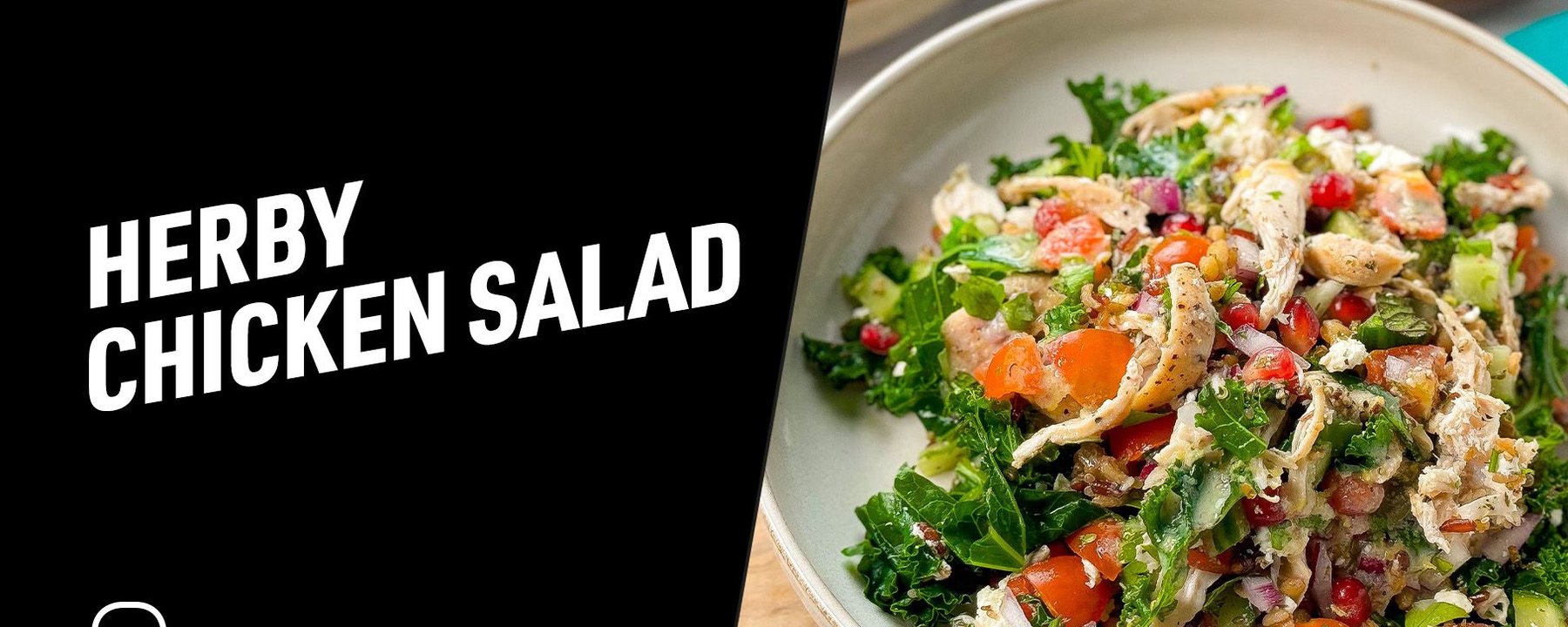 Bowl of herby chicken salad with kale, tomatoes, pomegranate seeds, and onions.