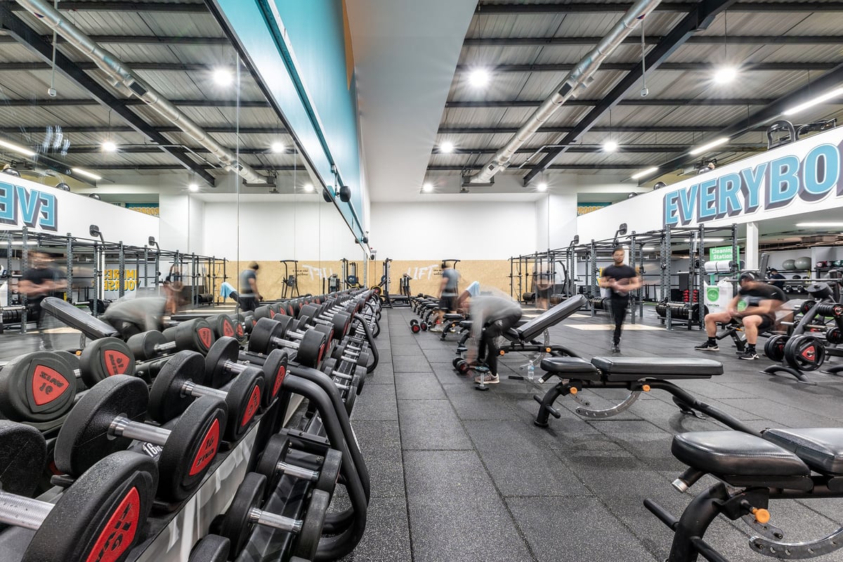 PureGym West Thurrock: Rows of stationary bikes, treadmills, and weight machines in a bright gym space.