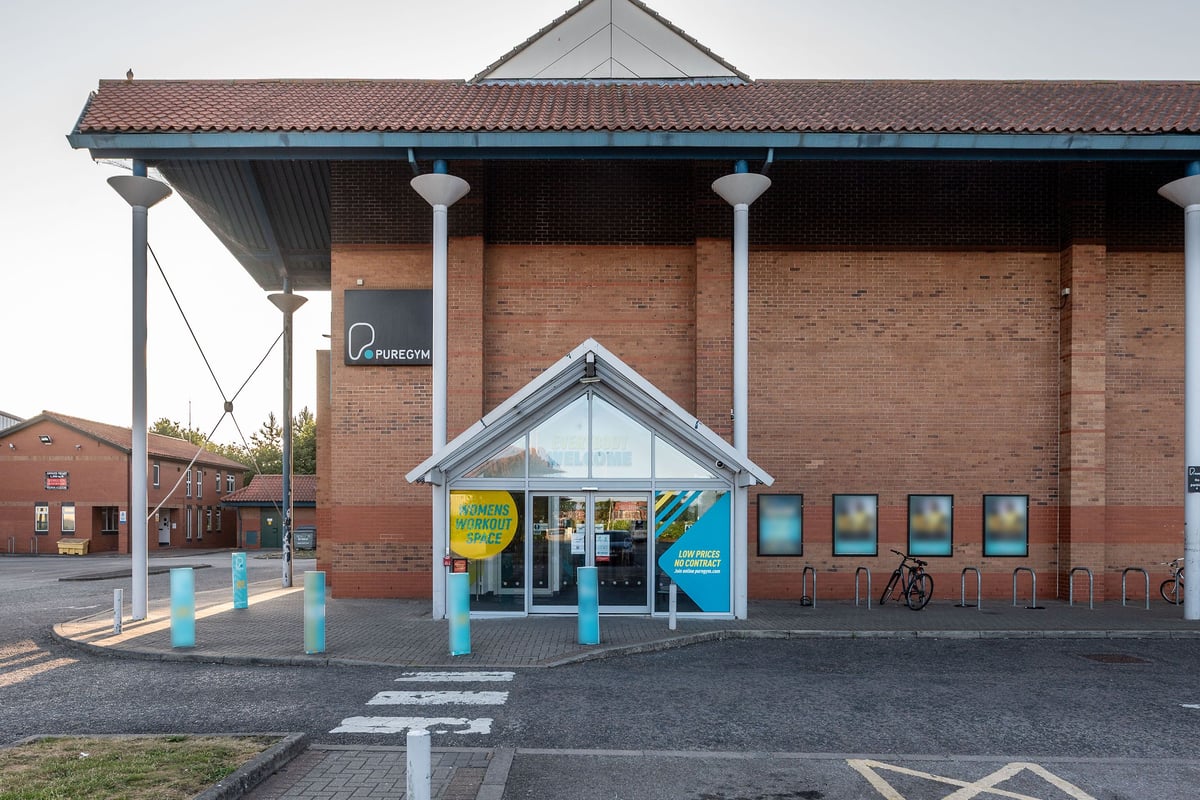 PureGym York: Exterior of a gym or fitness centre with bike racks and entrance signage.