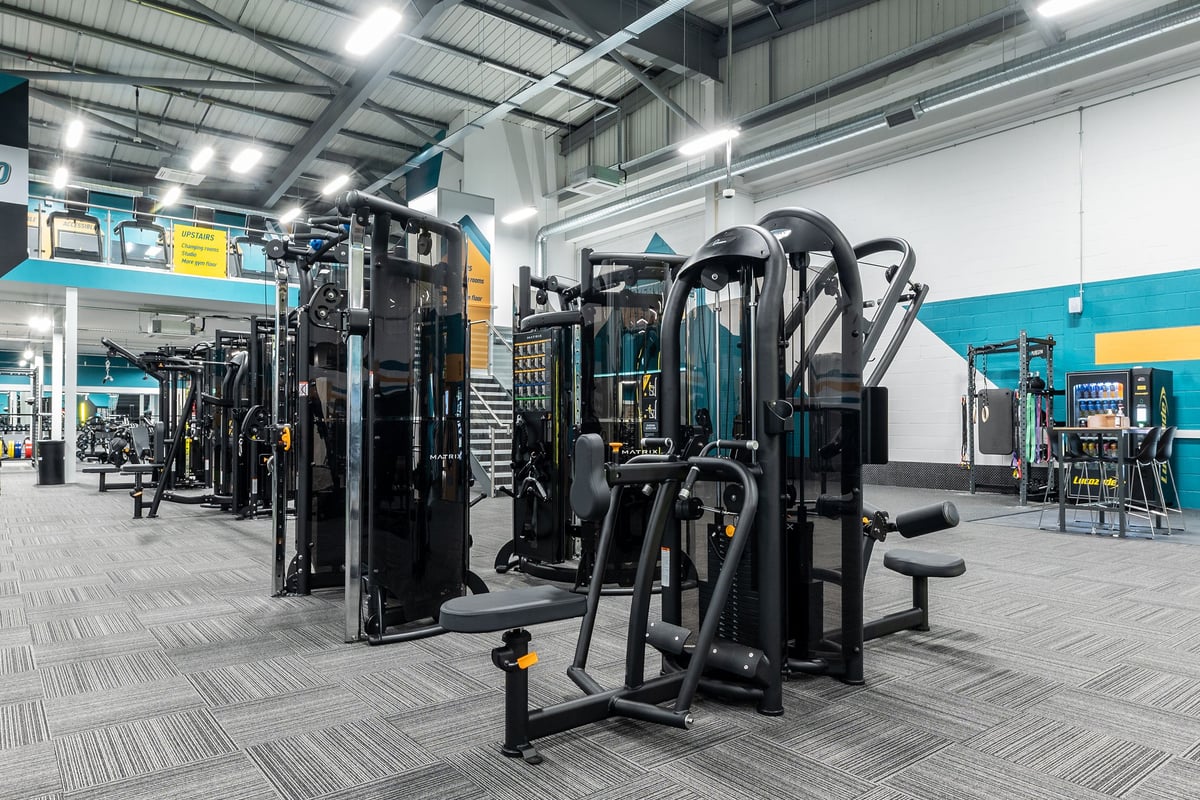 PureGym Watford Waterfields Retail Park: Weight machines, resistance equipment, rubberized flooring in a large gym facility.