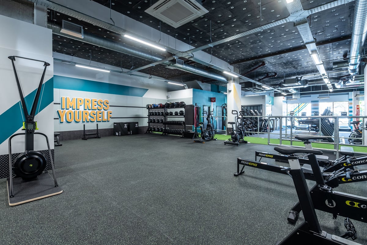 PureGym London Beckenham: Gym studio with free weights, resistance machines, benches, and rubberized flooring.