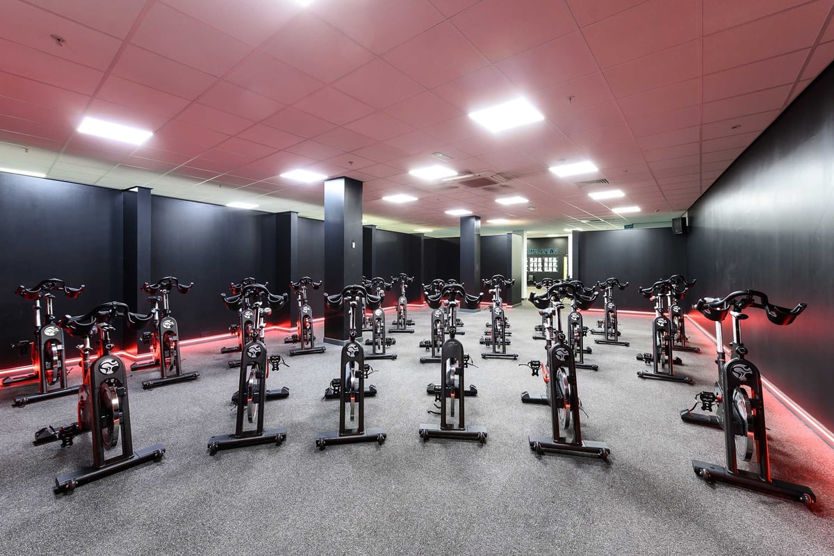 PureGym Glasgow Shawlands: Rows of spinning bikes in a brightly-lit gym studio.