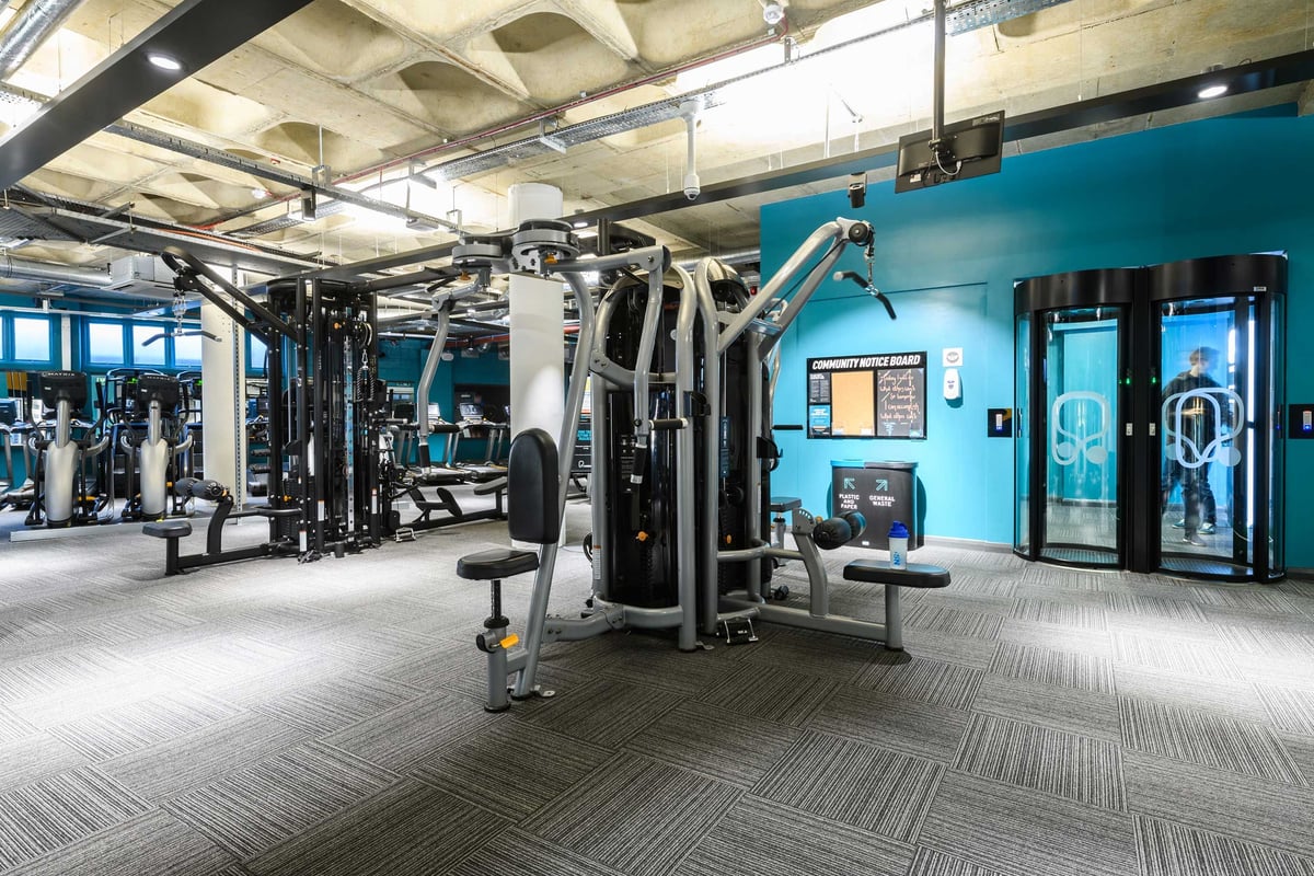 PureGym London Farringdon: Resistance equipment on rubberised flooring in spacious gym.
