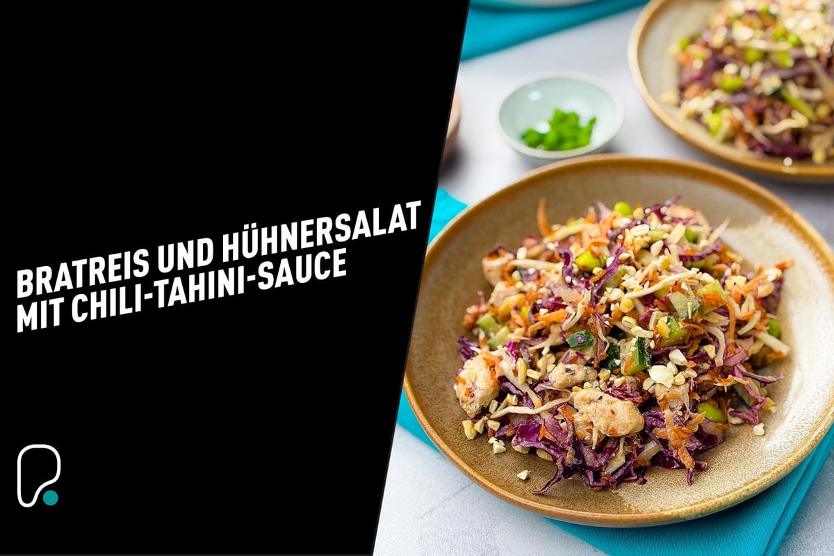 Plate with chicken salad and mixed vegetables on a blue napkin with a small bowl of herbs