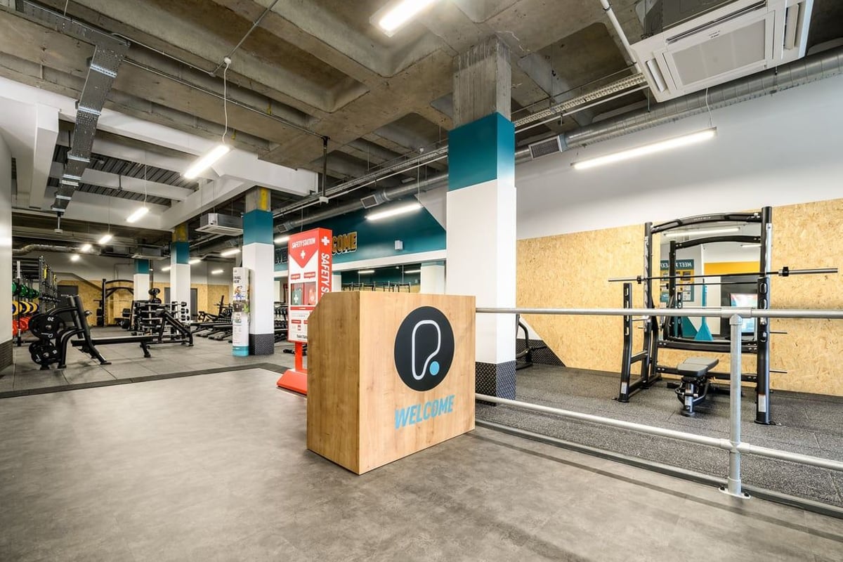 PureGym London Wimbledon: Resistance training area with squat racks, weight plates, plyo boxes, and functional training rigs.
