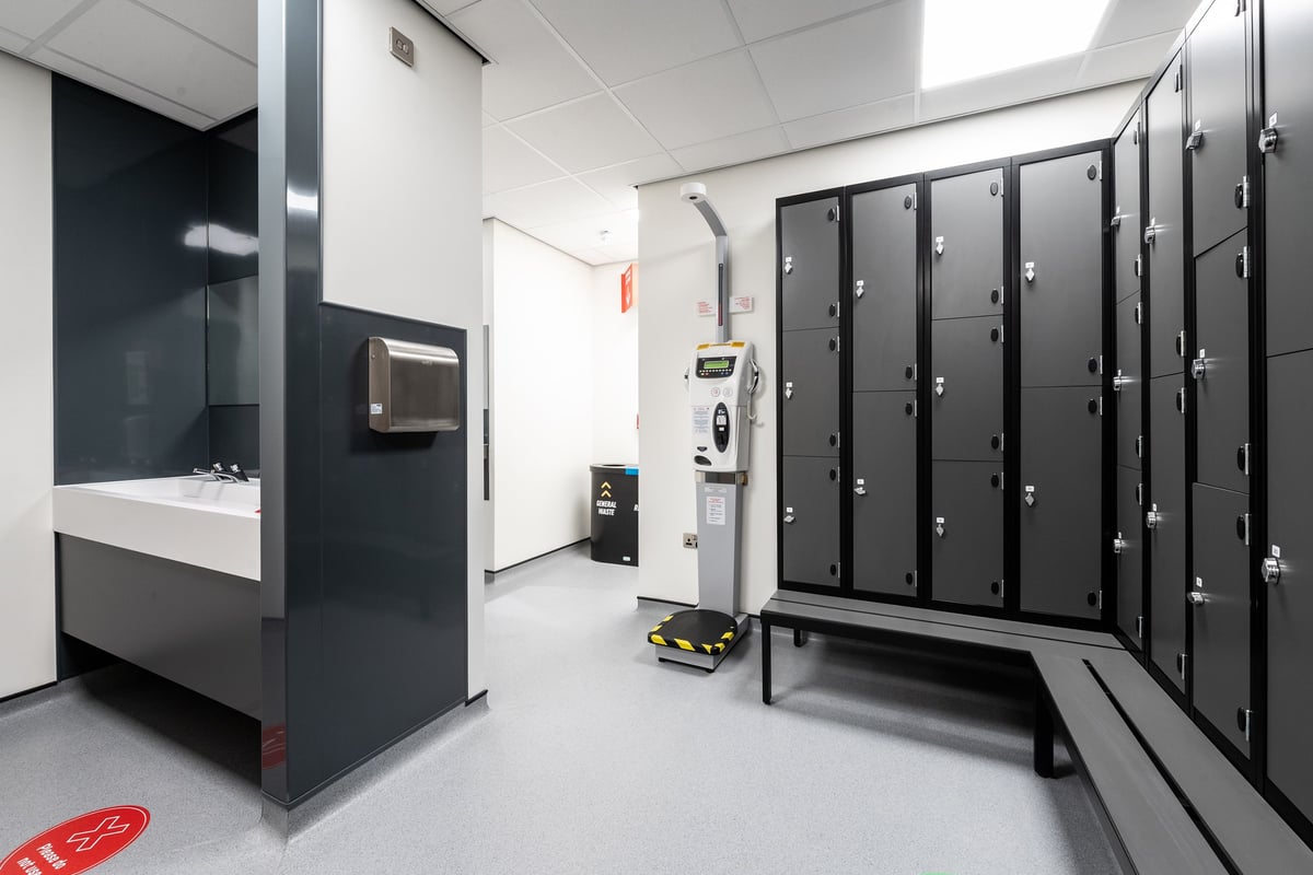 PureGym Aldershot Westgate Retail Park: Rows of lockers, a sink unit, and cleaning equipment - appears to be a changing room.