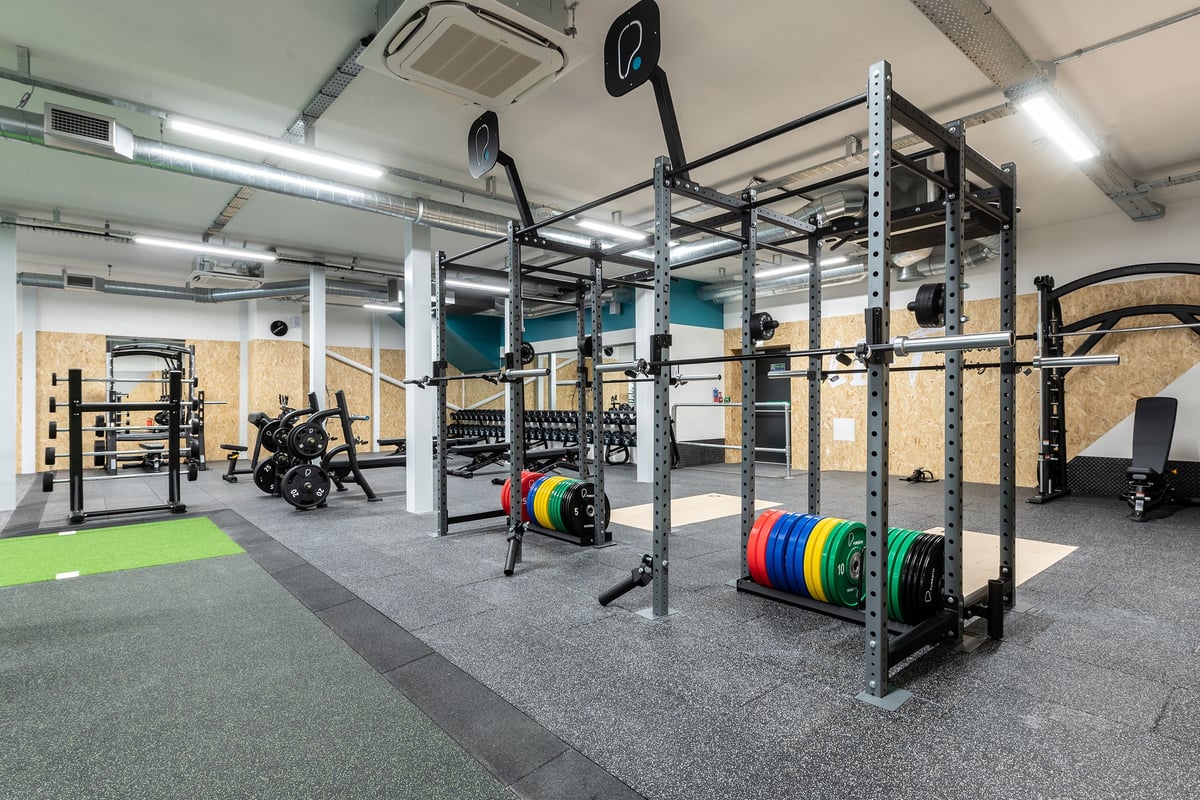 PureGym Northallerton: Squat racks, weight plates, rubberized flooring, and functional training equipment in a gym space.