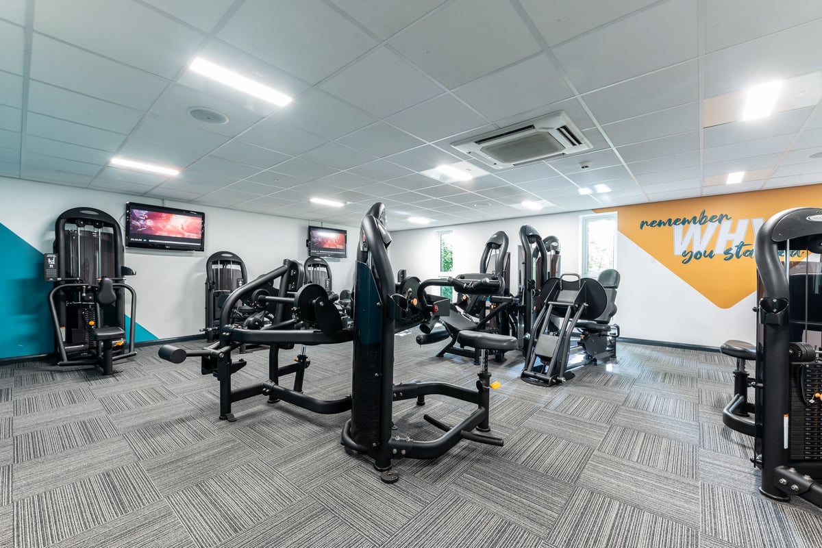 PureGym London Muswell Hill: Resistance training machines, exercise benches, rubberized flooring inside a gym studio.