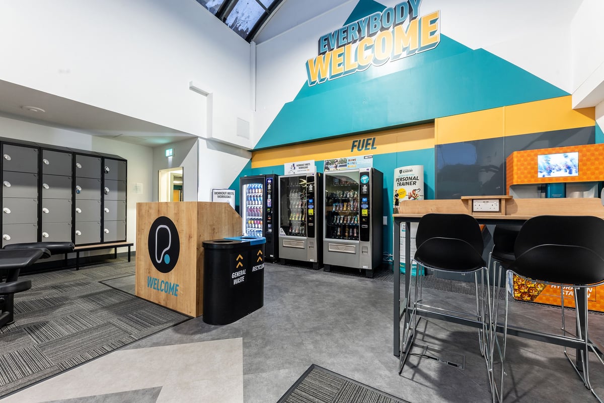 PureGym Purley: Vending machines, parcel lockers, seating area - appears to be a lobby or welcome area.