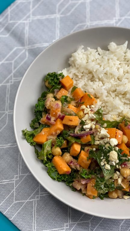 White rice served with a vegetable and chickpea salad topped with chopped nuts
