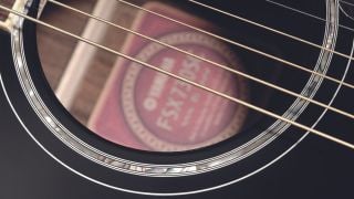 Close up of acoustic guitar strings on a Yamaha acoustic