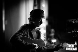 Timoth&eacute;e Chalamet, in the forthcoming movie, A Complete Unknown. Chalamet is pictured with one of two Gibson J-50 models made for the film