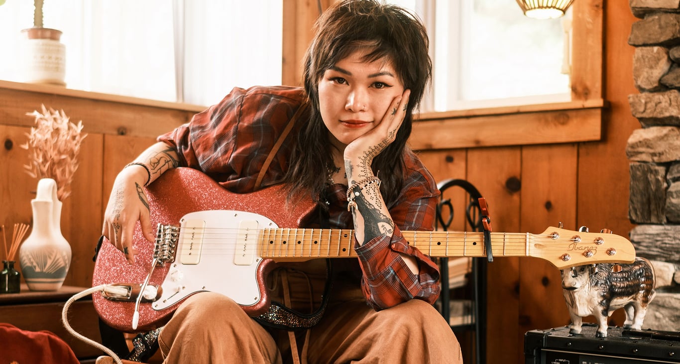 Yvette Young sits at home with her pink Ibanez Talman prototype with Wilkinson P-90 pickups.