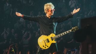 Billie Joe Armstrong playing Steve Jones' Les Paul on a stage at an arena