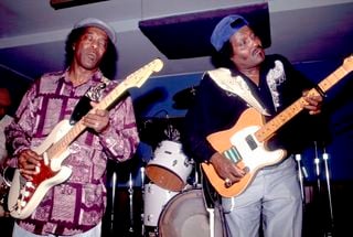 Buddy Guy (left) and Albert Collins perform onstage at the Legends nightclub in Chicago, Illinois in 1985