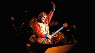 Mike Rutherford waves to the crowd after performing on stage with Genesis at the reunion concert 'Six of the Best' at The National Bowl on October 2nd, 1982 in Milton Keynes, United Kingdom.