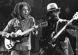 Bob Marley (left) and Aston &ldquo;Family Man&rdquo; Barrett perform onstage with the Wailers at the Odeon in Birmingham, England on July 18, 1975
