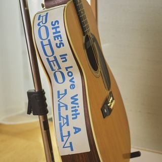 The sticker reading &rsquo;She's in love with a rodeo man&rsquo; that adorns the side of the guitar