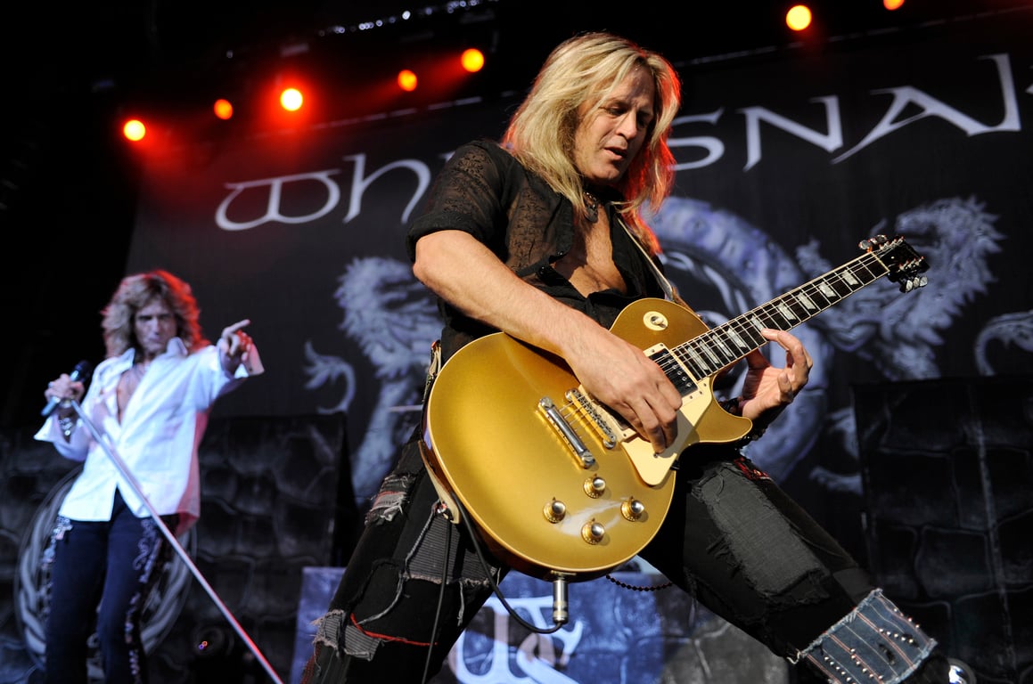 David Coverdale (left, background) points at Doug Aldrich (foreground) as the guitarist takes a solo on his Les Paul &ndash; at the Sleep Train Pavilion in Concord, California on July 31, 2009