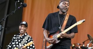 Buddy Guy and son Greg perform onstage together, with Greg taking a solo on his Telecaster and Buddy looking on with pride &ndash; he wears his trademark polka-dotted shirt.