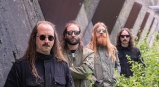A portrait of the cosmic death metal band Blood Incantation. The Denver, Colorado quartet wear dark sunglasses.